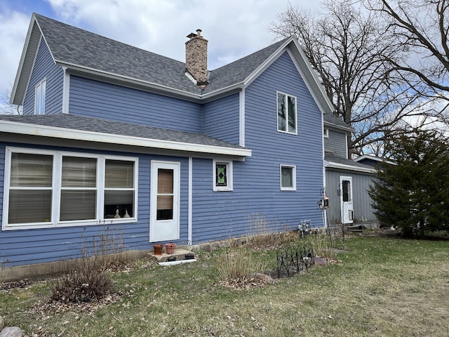 rear view of house with a yard