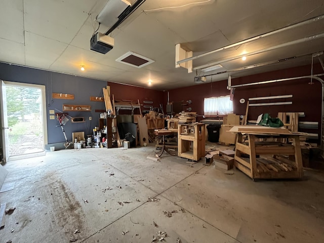 garage with a garage door opener and a workshop area