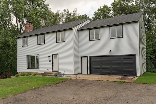 view of front of home featuring a garage and a front lawn