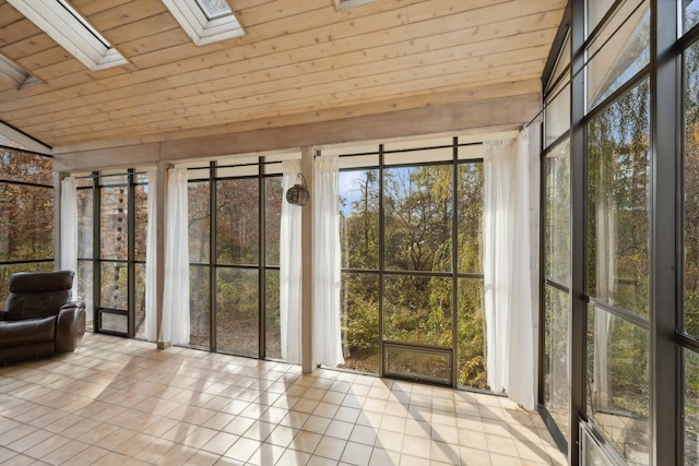 unfurnished sunroom with wood ceiling and a skylight