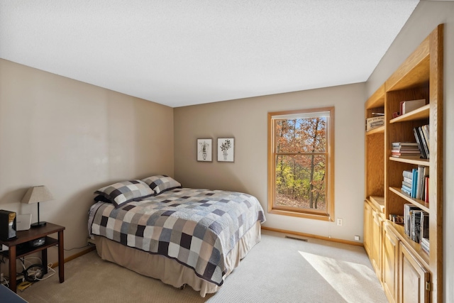 bedroom featuring light carpet