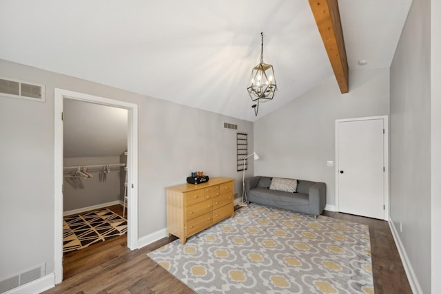 living area with vaulted ceiling with beams, an inviting chandelier, and dark wood-type flooring