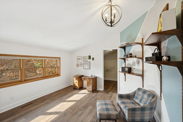 sitting room featuring lofted ceiling, light hardwood / wood-style flooring, and an inviting chandelier