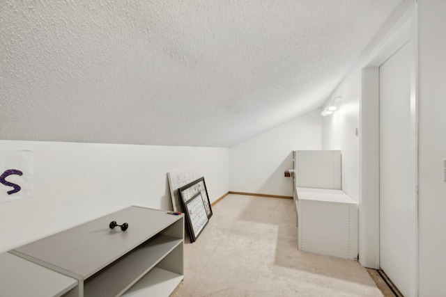 interior space featuring vaulted ceiling and a textured ceiling