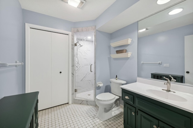 bathroom featuring vanity, toilet, tile patterned floors, and an enclosed shower