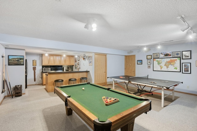 playroom with a textured ceiling, track lighting, pool table, and light colored carpet