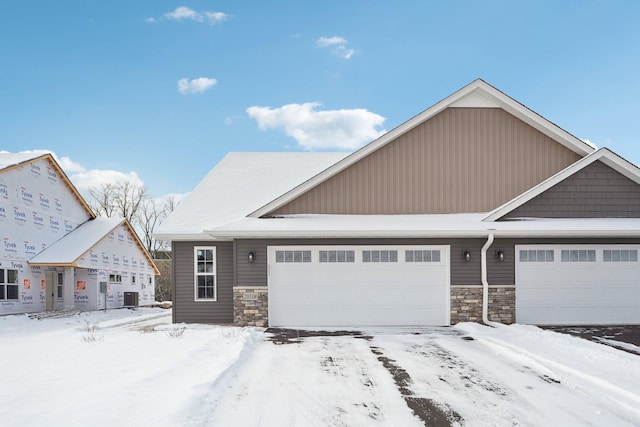 view of front of home featuring cooling unit and a garage