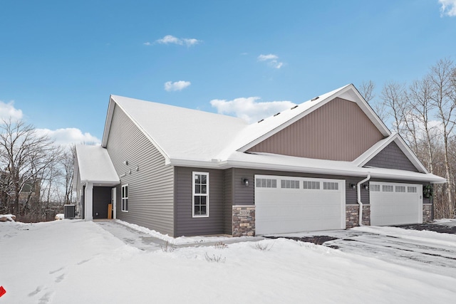 view of front of property with central AC and a garage