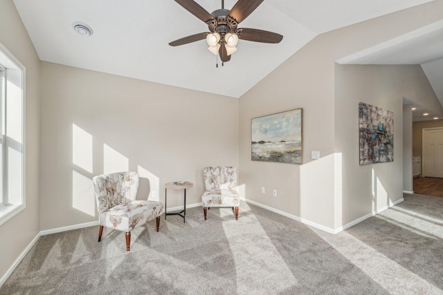 living area with ceiling fan, carpet, and lofted ceiling