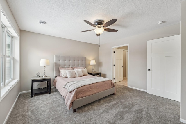 bedroom featuring carpet flooring, ceiling fan, and a textured ceiling