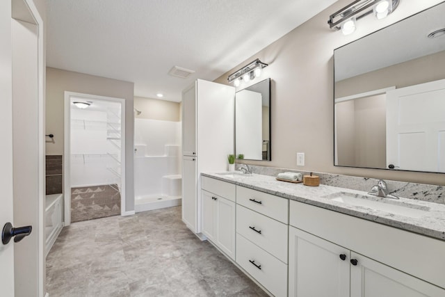 bathroom with a shower and vanity