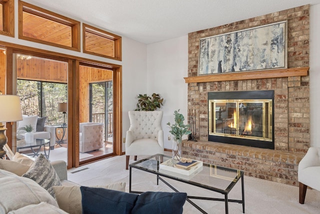 living room with a textured ceiling, light colored carpet, and a fireplace
