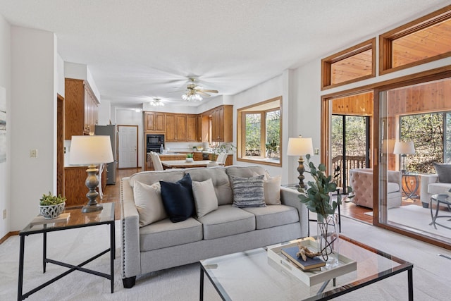 living room with ceiling fan and visible vents