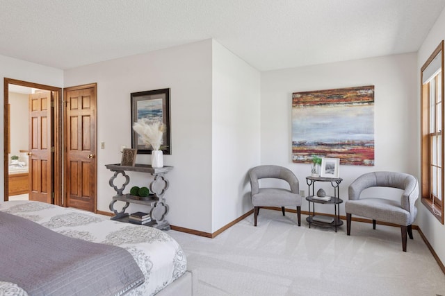 bedroom with a textured ceiling, baseboards, and light colored carpet