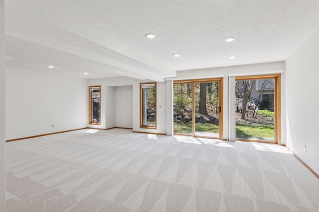 unfurnished living room featuring a textured ceiling, baseboards, light colored carpet, and recessed lighting