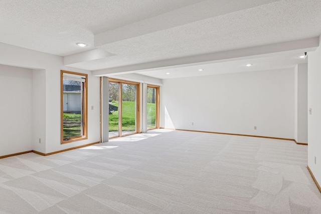 spare room with baseboards, recessed lighting, a textured ceiling, and light colored carpet