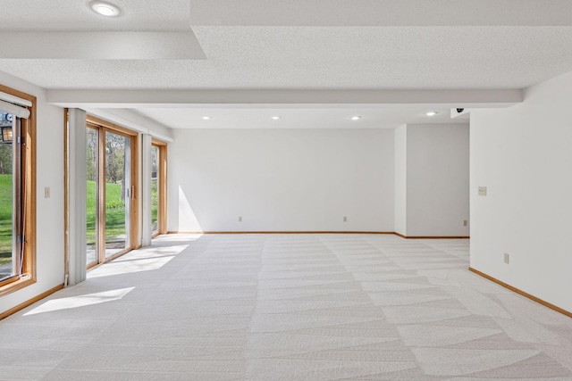 empty room featuring baseboards, recessed lighting, and light colored carpet