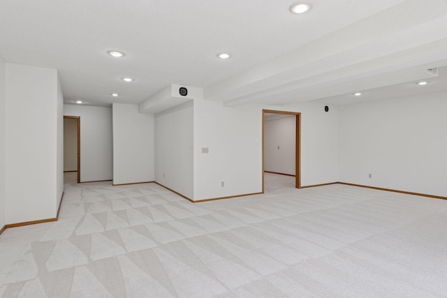 spare room featuring recessed lighting, baseboards, and light carpet