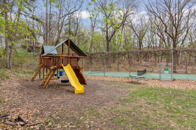 communal playground with fence and a tennis court