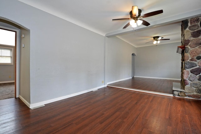 interior space with ceiling fan and dark hardwood / wood-style flooring