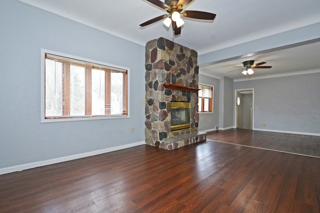 unfurnished living room with a fireplace, ceiling fan, and plenty of natural light