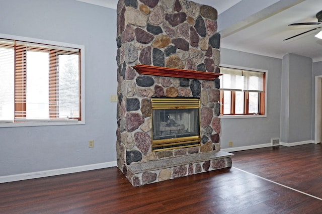 living room featuring ceiling fan, a fireplace, and dark hardwood / wood-style floors