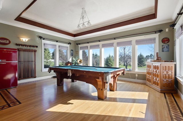 recreation room featuring ornamental molding, a healthy amount of sunlight, hardwood / wood-style floors, and billiards