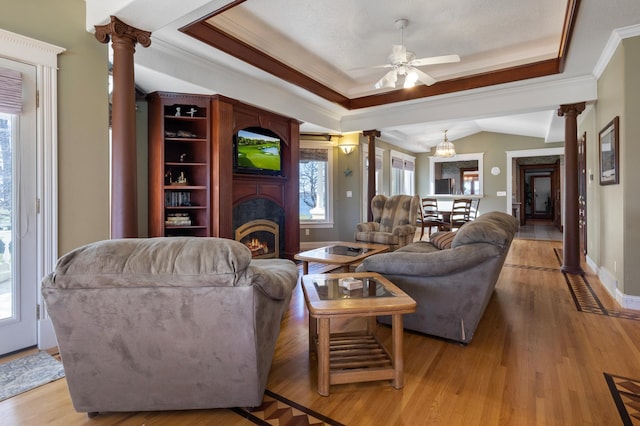 living room featuring ceiling fan, a healthy amount of sunlight, hardwood / wood-style flooring, and crown molding