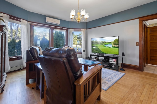 living room featuring a wall unit AC, an inviting chandelier, plenty of natural light, and light wood-type flooring