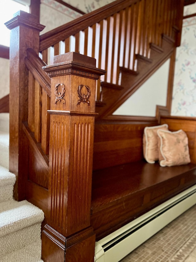 staircase featuring a baseboard heating unit