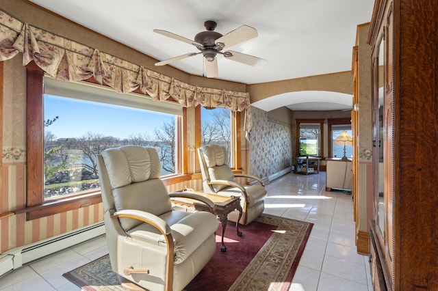 living area with ceiling fan, baseboard heating, and tile flooring
