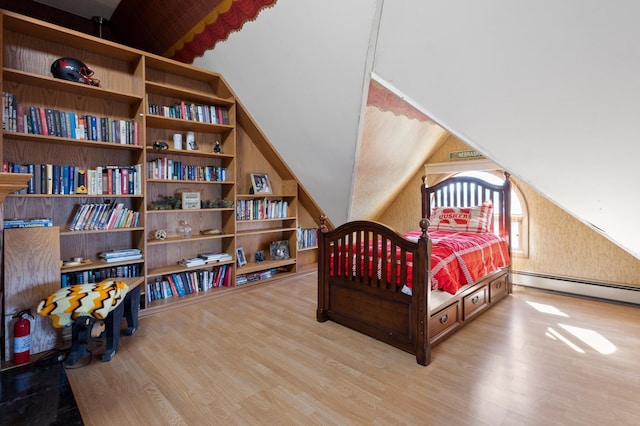 bedroom with vaulted ceiling, hardwood / wood-style flooring, and baseboard heating