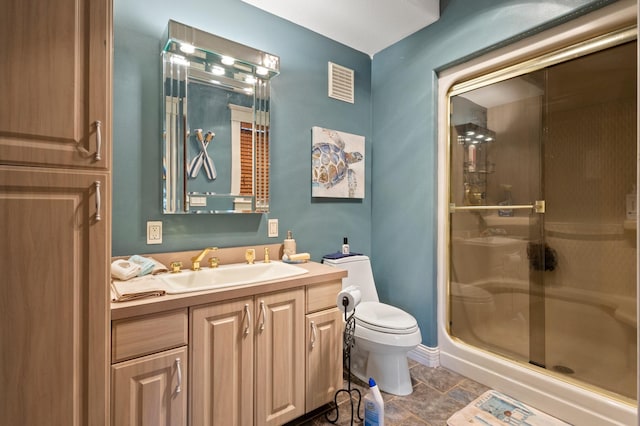 bathroom featuring an enclosed shower, toilet, tile floors, and vanity