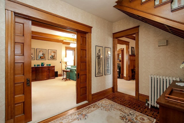 corridor with dark carpet and radiator heating unit