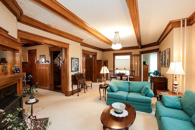 carpeted living room with beam ceiling and ornamental molding