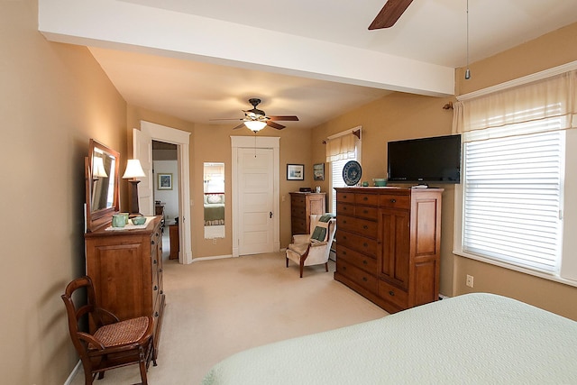 bedroom with ceiling fan, beam ceiling, and light colored carpet