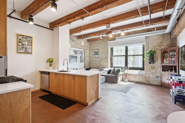 kitchen featuring kitchen peninsula, hanging light fixtures, dishwasher, sink, and brick wall