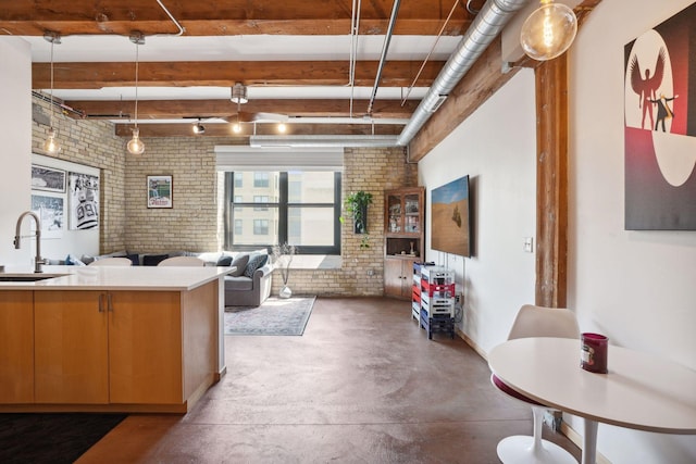 interior space featuring brick wall and sink