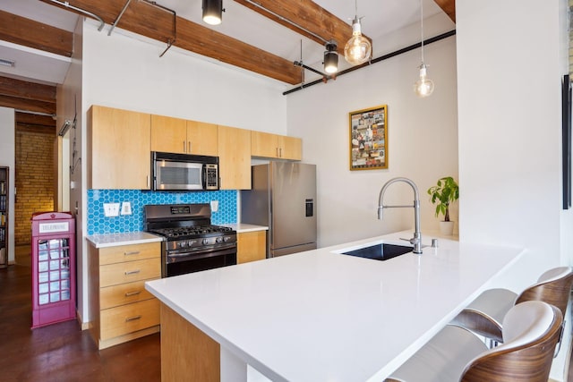 kitchen with backsplash, appliances with stainless steel finishes, beamed ceiling, pendant lighting, and sink