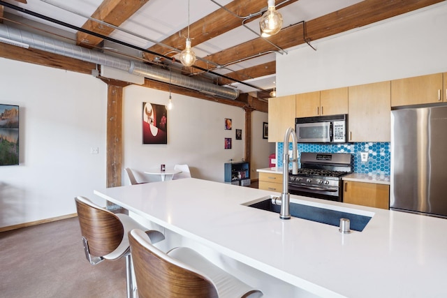 kitchen featuring beamed ceiling, a kitchen breakfast bar, pendant lighting, appliances with stainless steel finishes, and tasteful backsplash