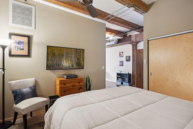 bedroom with a closet, ceiling fan, and beamed ceiling