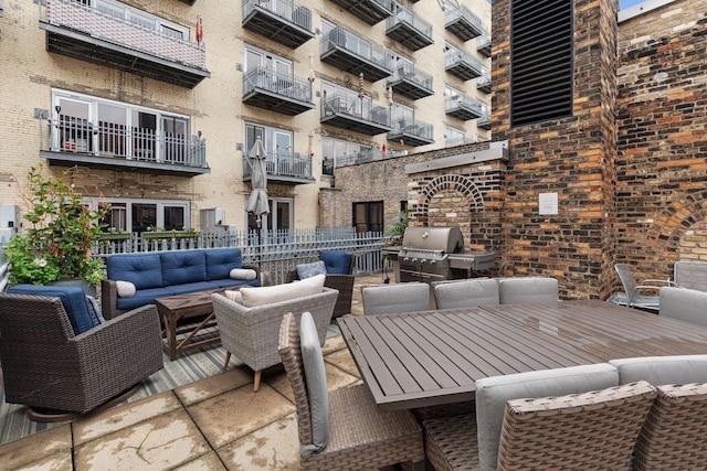 view of patio / terrace with an outdoor hangout area, a grill, and a balcony