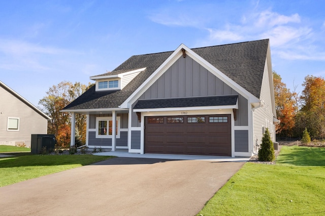 view of front facade with a front yard and a garage