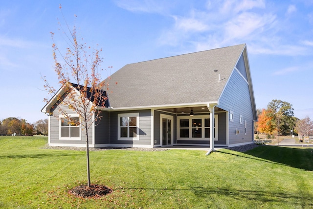 back of property featuring a patio area, a lawn, and ceiling fan