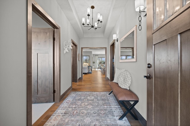 entrance foyer with a notable chandelier and dark hardwood / wood-style flooring