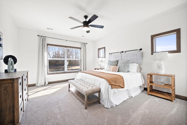 bedroom with ceiling fan and light carpet