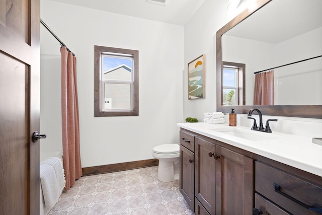 bathroom with vanity, a shower with curtain, toilet, and plenty of natural light