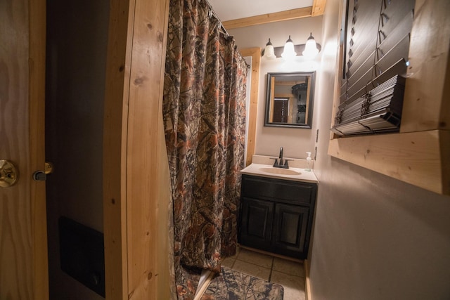 bathroom featuring tile patterned flooring, vanity, and curtained shower