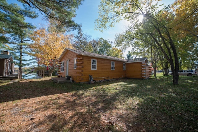 rear view of property with a yard