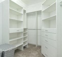 walk in closet with light tile floors